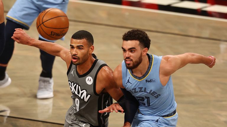 Timothe Luwawu-Cabarrot #9 of the Brooklyn Nets and Tyus Jones #21 of the Memphis Grizzlies pursue the loose ball at Barclays Center on December 28, 2020 in New York City.