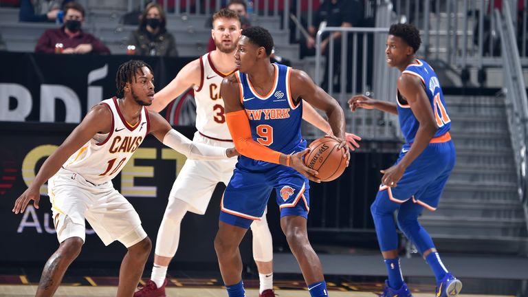RJ Barrett #9 of the New York Knicks looks to pass the ball while Darius Garland #10 of the Cleveland Cavaliers plays defense during the game on December 29, 2020 at Rocket Mortgage FieldHouse in Cleveland, Ohio.