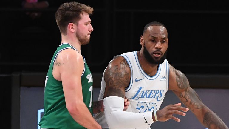 LeBron James #23 of the Los Angeles Lakers handles the ball against Luka Doncic #77 of the Dallas Mavericks during the game on December 25, 2020