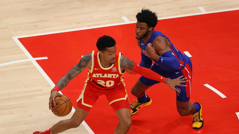 John Collins #20 of the Atlanta Hawks is defended by Saddiq Bey #41 of the Detroit Pistons during the first half at State Farm Arena on December 28, 2020 in Atlanta, Georgia. 