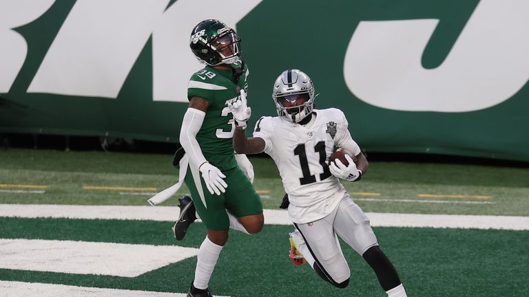 Henry Ruggs III #11 of the Las Vegas Raiders reacts after scoring a touchdown in the final seconds of the second half as Lamar Jackson #38 of the New York Jets looks on at MetLife Stadium on December 06, 2020 in East Rutherford, New Jersey. 