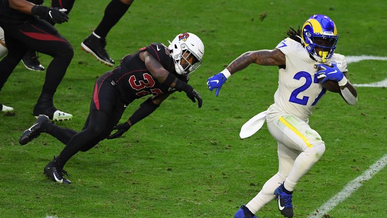 Running back Darrell Henderson #27 of the Los Angeles Rams runs the ball for a touchdown as strong safety Budda Baker #32 of the Arizona Cardinals defends during the second half at State Farm Stadium on December 06, 2020 in Glendale, Arizona.