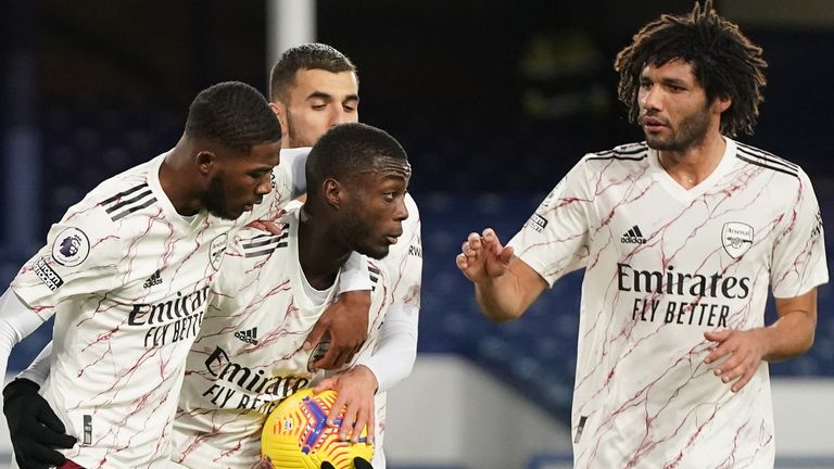 Nicolas Pepe celebrates with teammates Ainslie Maitland-Niles, Mohamed El Niny and Danny Ceballos after scoring their first team goal from a penalty kick during the Premier League match between Everton and Arsenal at Goodison Park