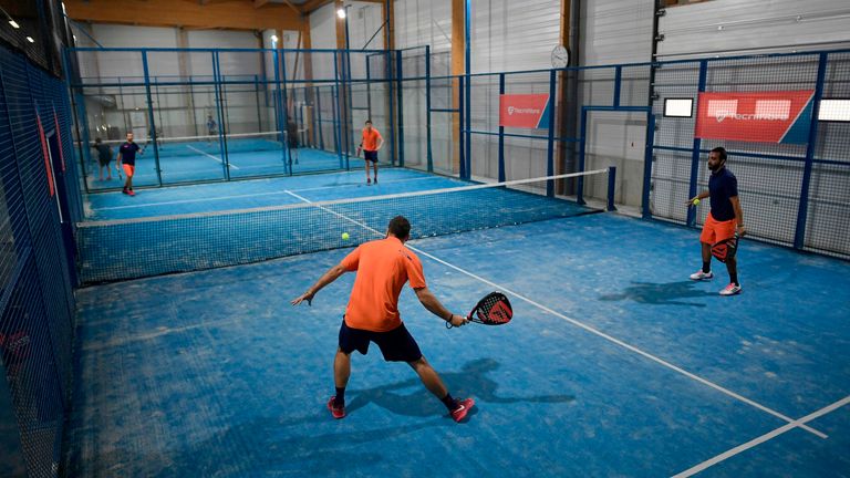 People play a padel match on October 10, 2017 in Bois d'Arcy near Paris. Tennis champions like Nadal and Monfils have raise a new interest in padel, a trendy derivative of tennis.