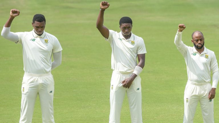 South Africa players Lungi Ngidi, Lutho Sipamla and Temba Bavuma raise their fists before the first Test against Sri Lanka