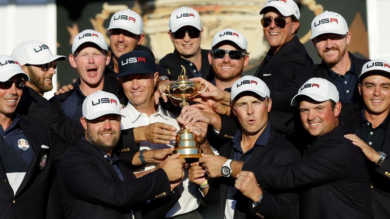 United States captain Davis Love III is surrounded by his players as they pose for a picture during the closing ceremony of the Ryder Cup golf tournament Sunday, Oct. 2, 2016, at Hazeltine National Golf Club in Chaska, Minn. (AP Photo/David J. Phillip)
