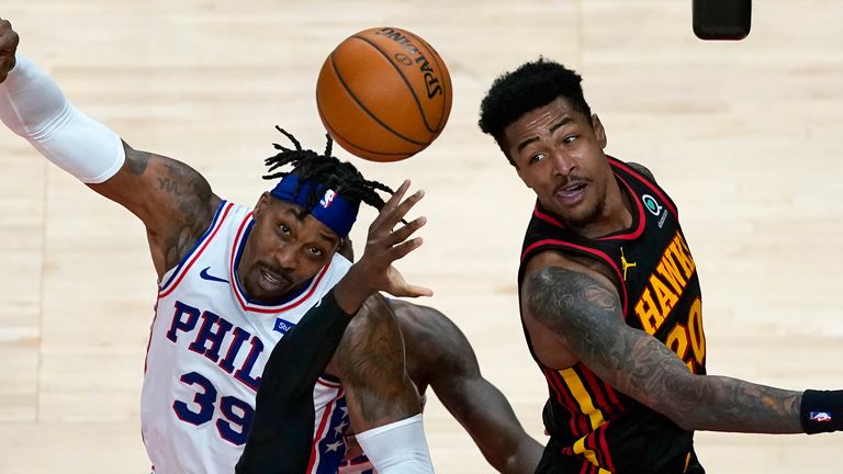 Philadelphia 76ers center Dwight Howard (39) and Atlanta Hawks forward John Collins (20) battle for a rebound during the second half of an NBA basketball game Monday, Jan. 11, 2021, in Atlanta. 