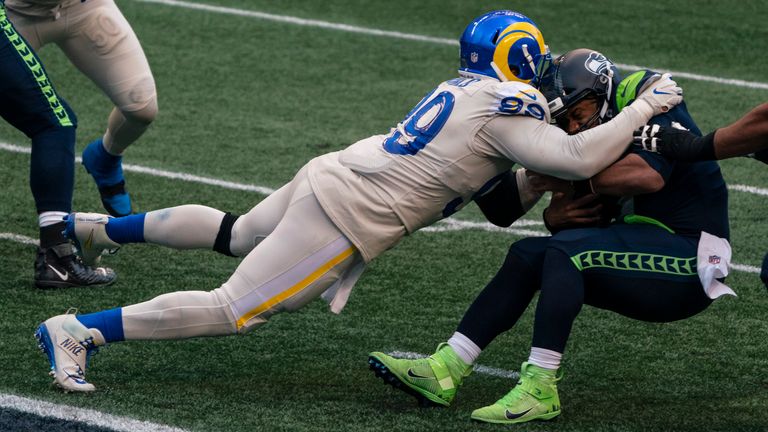 Los Angeles Rams defensive lineman Aaron Donald sacks Seattle Seahawks quarterback Russell Wilson during the second half of an NFL football game, Sunday, Dec. 27, 2020, in Seattle. The Seahawks won 20-9. (AP Photo/Stephen Brashear)