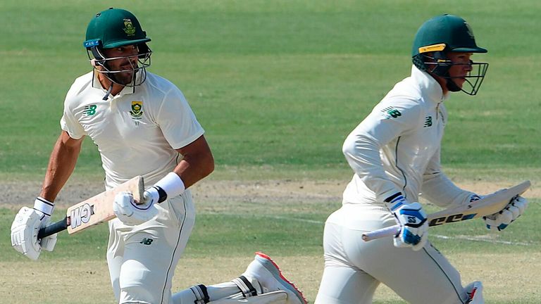 South Africa's Aiden Markram (L) and Rassie van der Dussen (C) run between the wickets as Pakistan's Fawad Alam watches during the third day of the first cricket Test match between Pakistan and South Africa at the National Stadium in Karachi on January 28, 2021. (Photo by Asif HASSAN / AFP) (Photo by ASIF HASSAN/AFP via Getty Images)