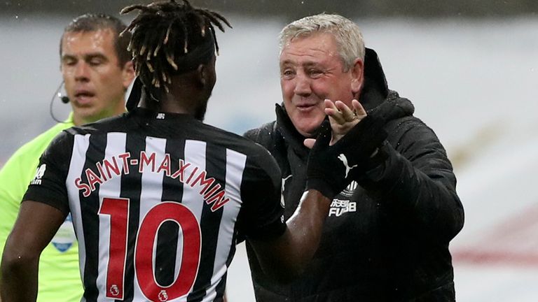 Newcastle's Allan Saint-Maximin, left, celebrates with Newcastle's head coach Steve Bruce after scoring his side's opening goal during the English Premier League soccer match between Newcastle United and Burnley at St. James' Park in Newcastle, England, Saturday, Oct. 3, 2020.
