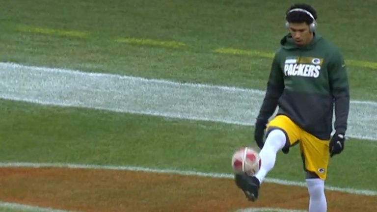 Allen Lazard warms up by playing some football