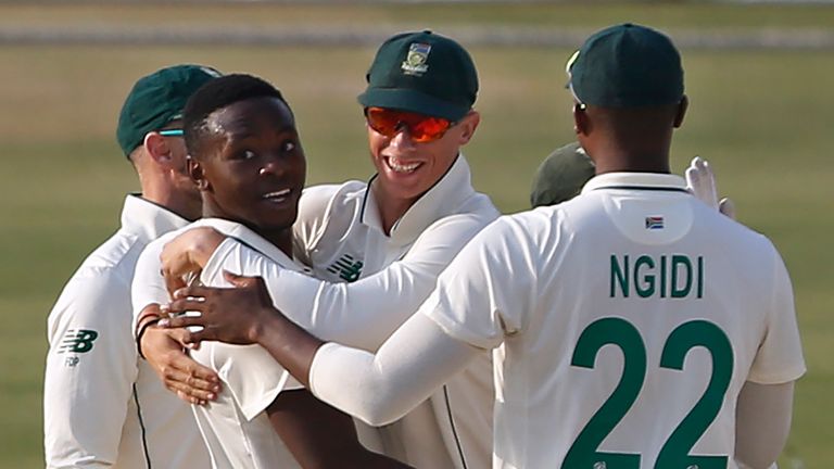 South Africa pacer Kagiso Rabada, second left, celebrates with teammates after taking the wicket of Pakistan batsman Imran Butt during the first day of the first Test between Pakistan and South Africa at the National Stadium, in Karachi, Pakistan, Tuesday, Jan. 26, 2021.(AP Photo/Anjum Naveed)