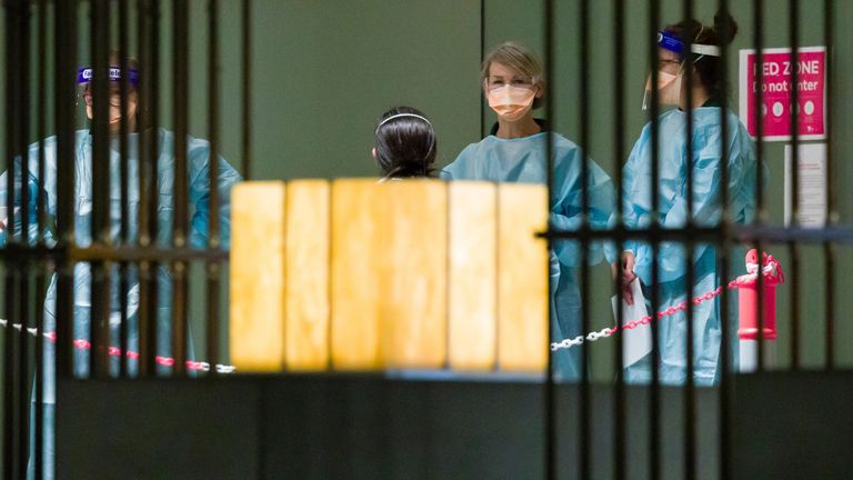 Quarantine staff wait for the arrival of tennis players ahead of the 2021 Australian Open tennis tournament