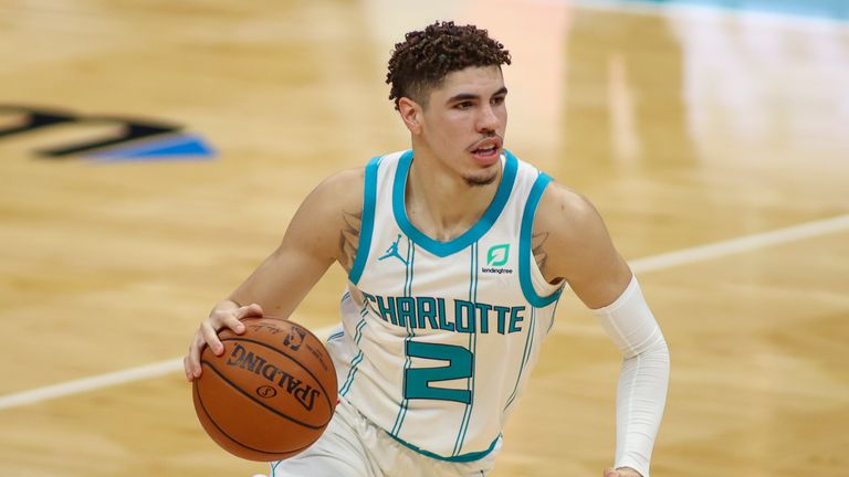 Charlotte Hornets guard LaMelo Ball brings the ball up court against the New York Knicks in the second half of an NBA basketball game in Charlotte