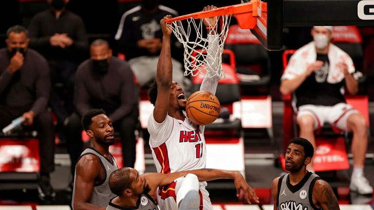 AP - Miami Heat center Bam Adebayo dunks over Brooklyn Nets forward Kevin Durant (7) and guard Kyrie Irving (11)