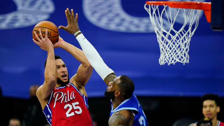 Philadelphia 76ers' Ben Simmons goes up for a shot against Los Angeles Lakers' LeBron James