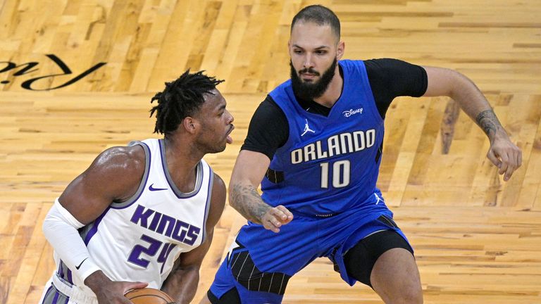 Buddy Hield holds of Evan Fournier during the Kings win over Orlando (AP Photo/Phelan M. Ebenhack)