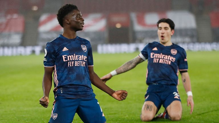 Arsenal's Bukayo Saka celebrates after scoring his side's second goal (AP)