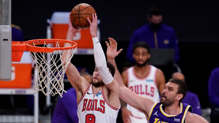 Chicago Bulls guard Zach LaVine dunks next to Los Angeles Lakers center Marc Gasol