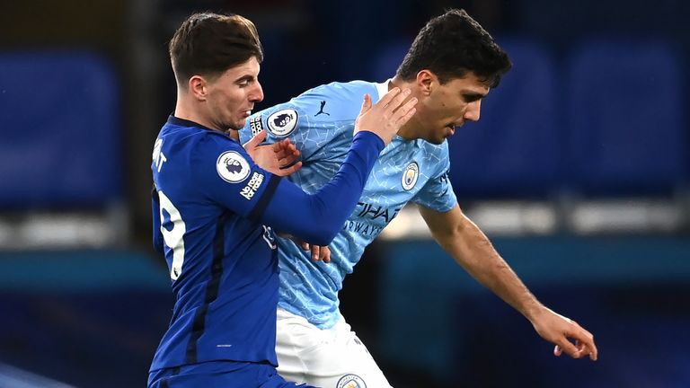 Mason Mount and Rodri battle for possession