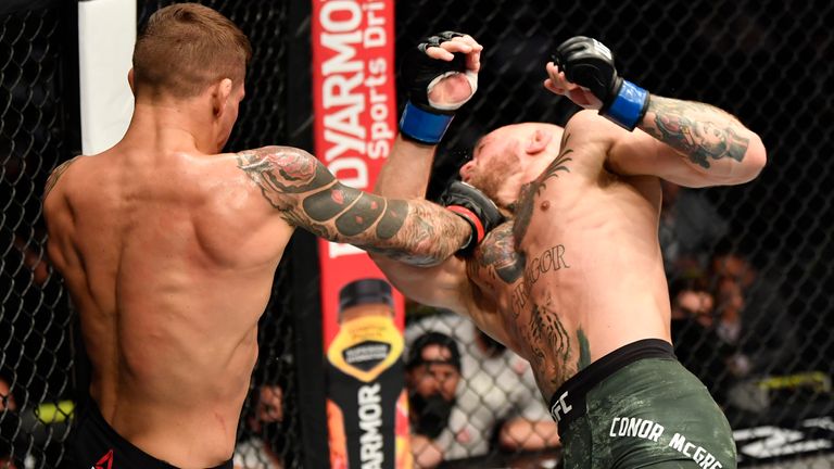 ABU DHABI, UNITED ARAB EMIRATES - JANUARY 23: (L-R) Dustin Poirier punches Conor McGregor of Ireland in a lightweight fight during the UFC 257 event inside Etihad Arena on UFC Fight Island on January 23, 2021 in Abu Dhabi, United Arab Emirates. (Photo by Jeff Bottari/Zuffa LLC)