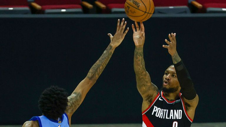 AP - Portland Trail Blazers guard Damian Lillard (0) shoots as Houston Rockets center Christian Wood (35) defends 