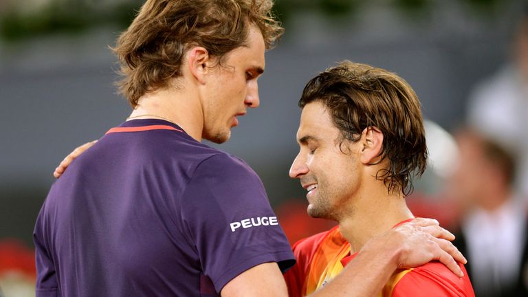 David Ferrer, from Spain, left, embraces Alexander Zverev, from Germany, after losing his last match as a professional tennis player during the Madrid Open tennis tournament, Wednesday, May 8, 2019, in Madrid, Spain