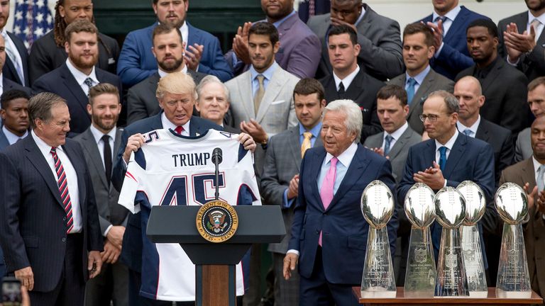 President Donald Trump is presented with a New England Patriots jersey by Patriots head coach Bill Belichick, left, and New England Patriots owner Robert Kraft, center, during a ceremony on the South Lawn of the White House in Washington, Wednesday, April 19, 2017, where the president honored the Super Bowl Champion New England Patriots for their Super Bowl LI victory. Also pictured is New England Patriots president Jonathan Kraft, second from right.