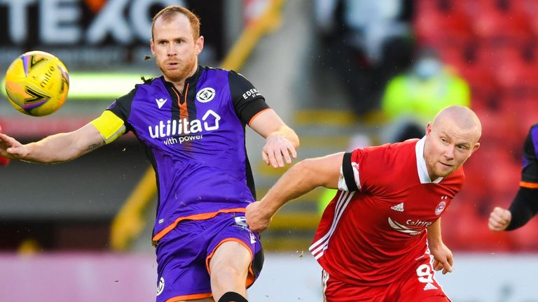 Dundee United captain Mark Reynolds and Aberdeen's Cutris Main in action