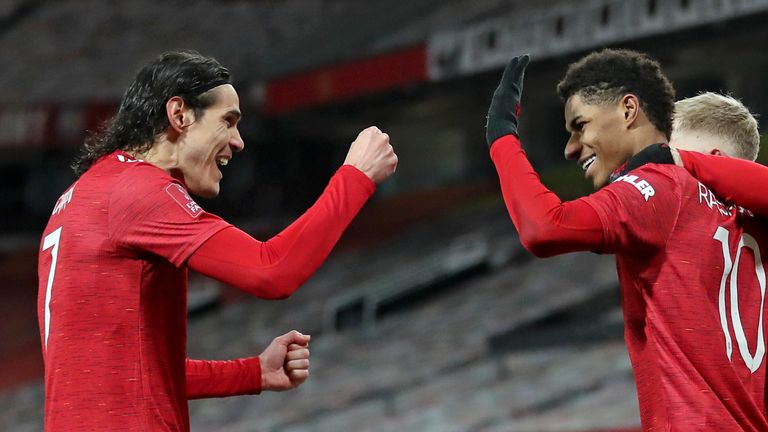 Manchester United...s Marcus Rashford, right, celebrates with Edinson Cavani after scoring his side...s second goal during the English FA Cup 4th round soccer match between Manchester United and Liverpool at Old Trafford in Manchester, England, Sunday, Jan. 24, 2021. (Martin Rickett/Pool via AP)..