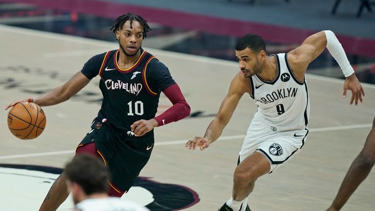 Cleveland Cavaliers&#39; Darius Garland (10) drives past Brooklyn Nets&#39; Timothe Luwawu-Cabarrot (9) in the first half of an NBA basketball game, Friday, Jan. 22, 2021, in Cleveland. (AP Photo/Tony Dejak)


