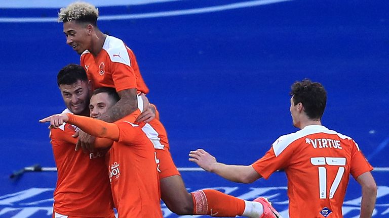 Blackpool's Gary Madine (left) celebrates scoring his side's first goal of the game against Brighton