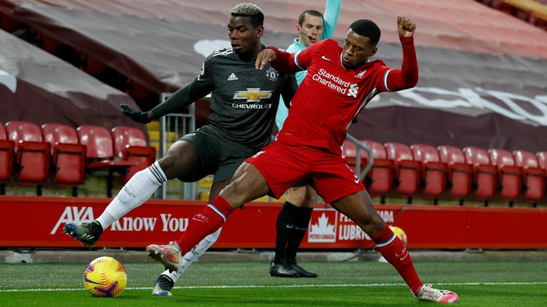 Georginio Wijnaldum challenges Paul Pogba for possession (AP)