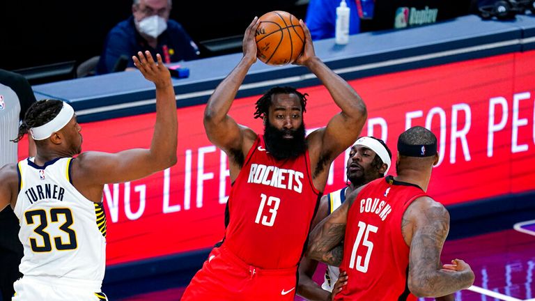 AP- Houston Rockets guard James Harden (13) makes a pass in front of  forward Myles Turner (33)