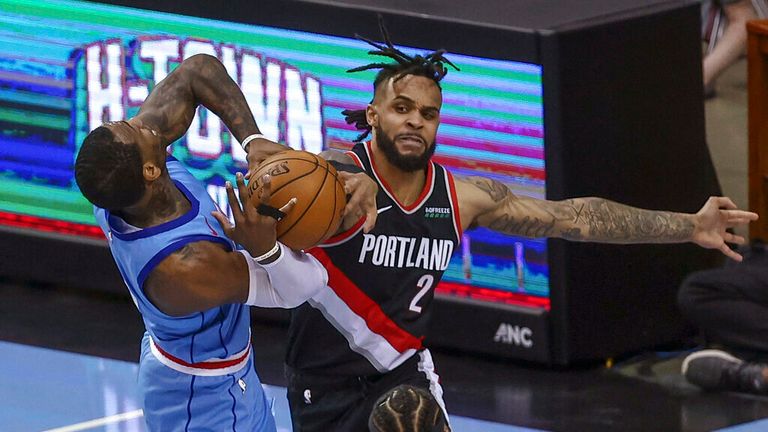 AP - Houston Rockets guard John Wall, left, is defended by Portland Trail Blazers guard Gary Trent Jr. (2) during the second quarter 