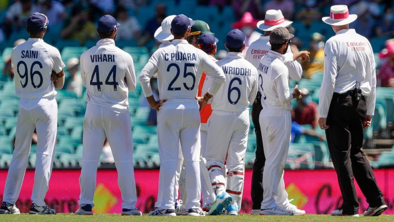 Indian players talk with the umpires after an issue with the crowd during play on day four of the third cricket test between India and Australia at the Sydney Cricket Ground, Sydney, Australia, Sunday, Jan. 10, 2021. (AP Photo/Rick Rycroft)