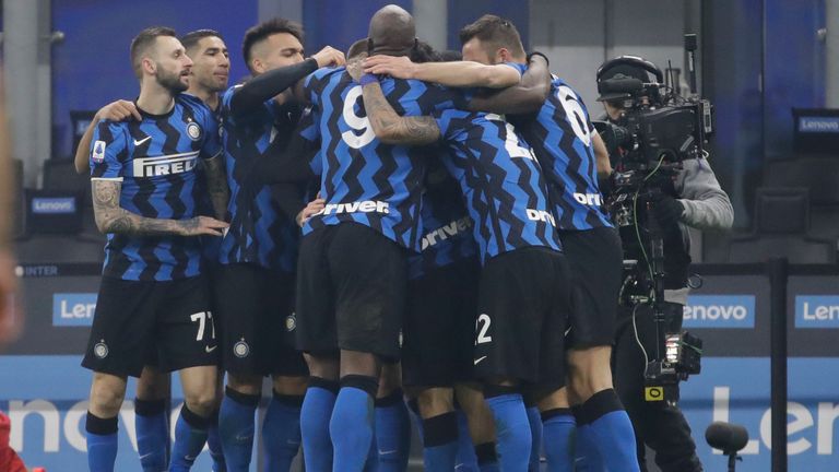 Inter Milan players celebrate after Nicolo Barella scored his side's second goal during a Serie A soccer match between Inter Milan and Juventus at the San Siro stadium in Milan, Italy, Sunday, Jan. 17, 2021. (AP Photo/Luca Bruno)