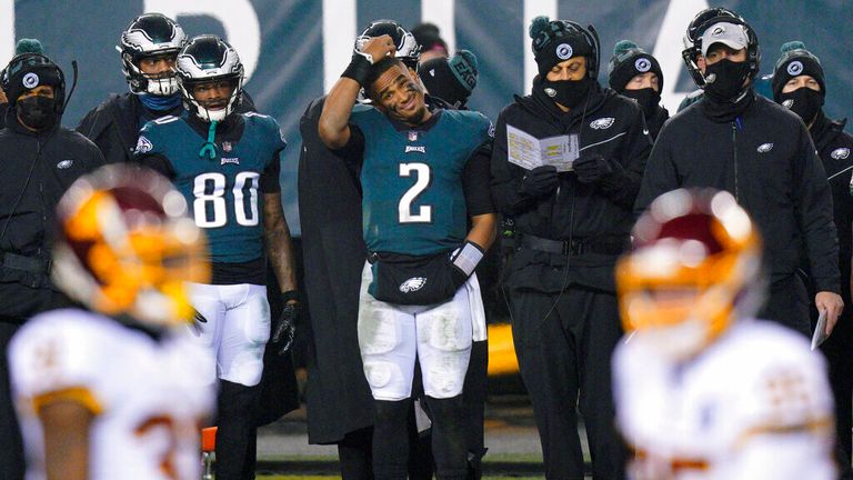 AP- Philadelphia Eagles&#39; Jalen Hurts scratches his head on the sideline during the second half of an NFL football game against the Washington Football Team