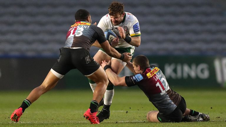 London Irish's James Stokes is tackled by Harlequins' Joe Marchant and James Lang