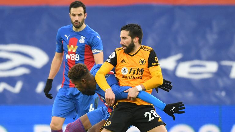 Joao Moutinho gets to grips with Wilfried Zaha in the Premier League game