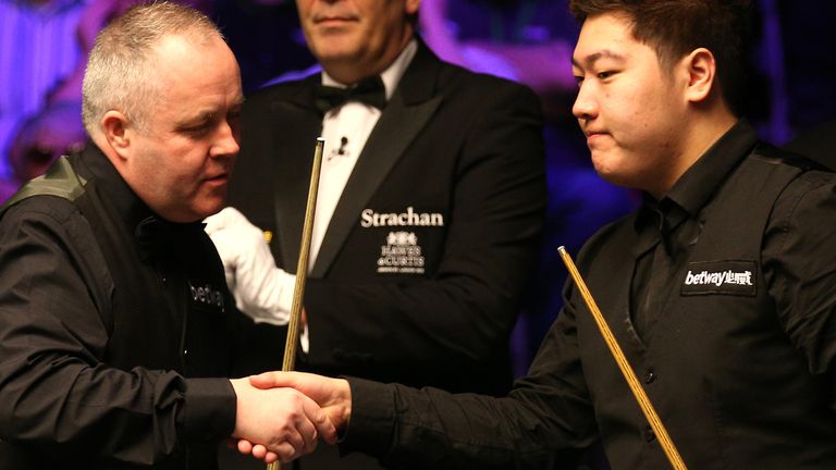 John Higgins (left) shakes hands with Yan Bingtao during day ten of the Betway UK Championship at the York Barbican.