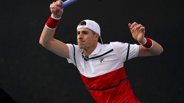 John Isner of the U.S. makes a forehand return to Chile's Alejandro Tabilo during their second round singles match at the Australian Open tennis championship in Melbourne, Australia, Thursday, Jan. 23, 2020. (AP Photo/Lee Jin-man)