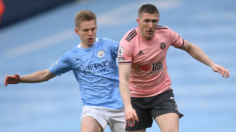 John Lundstram is challenged by Manchester City's Oleksandr Zinchenko (AP)