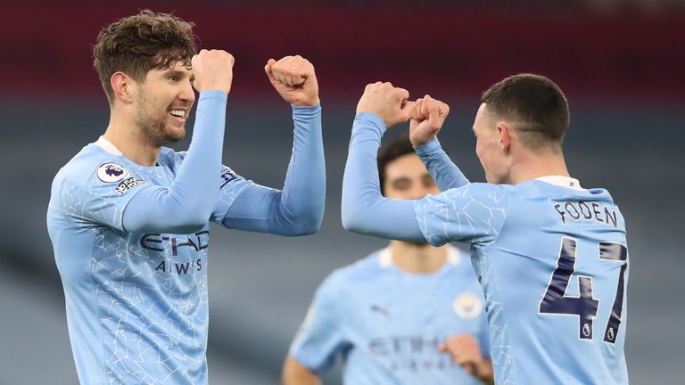 John Stones celebrates scoring Man City's third goal with Phil Foden