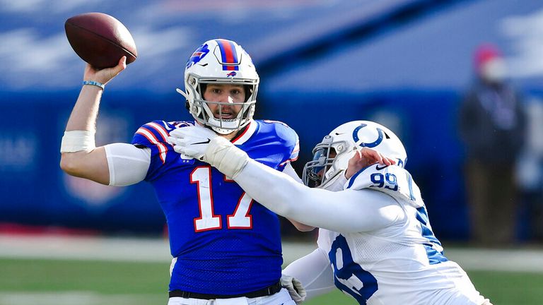 AP - Buffalo Bills quarterback Josh Allen (17) throws a pass as he is hit by Indianapolis Colts&#39; DeForest Buckner (99)