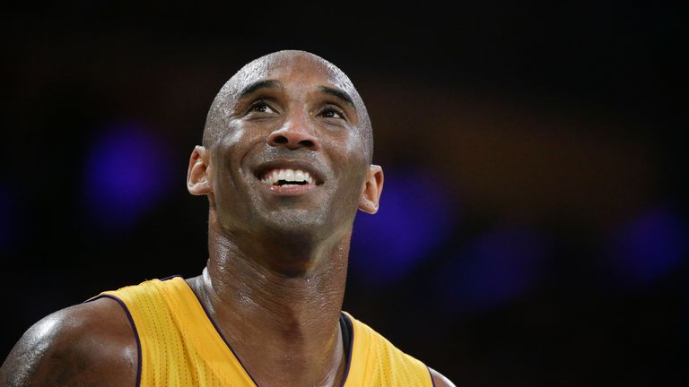Kobe Bryant smiles during the first half of Bryant's last NBA basketball game, against the Utah Jazz in Los Angeles