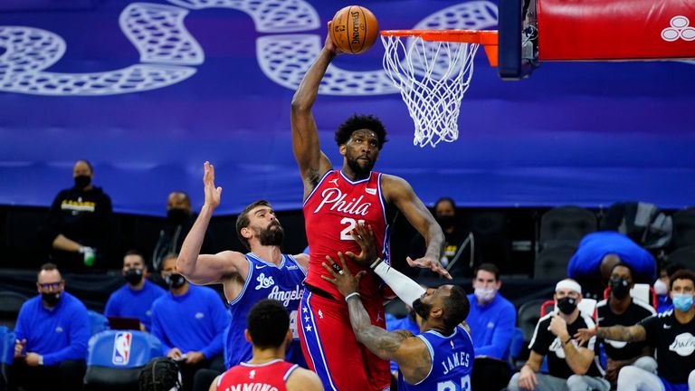 Philadelphia 76ers&#39; Joel Embiid goes up for a shot between Los Angeles Lakers&#39; LeBron James and Marc Gasol
