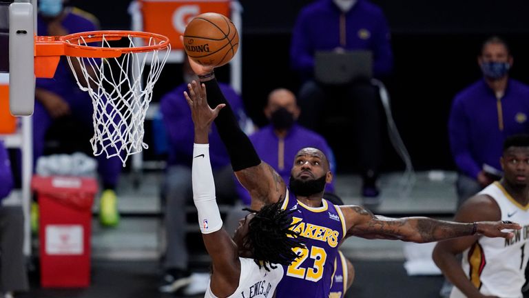 Los Angeles Lakers forward LeBron James (23) defends against New Orleans Pelicans guard Kira Lewis Jr. (13) during the fourth quarter of an NBA basketball game