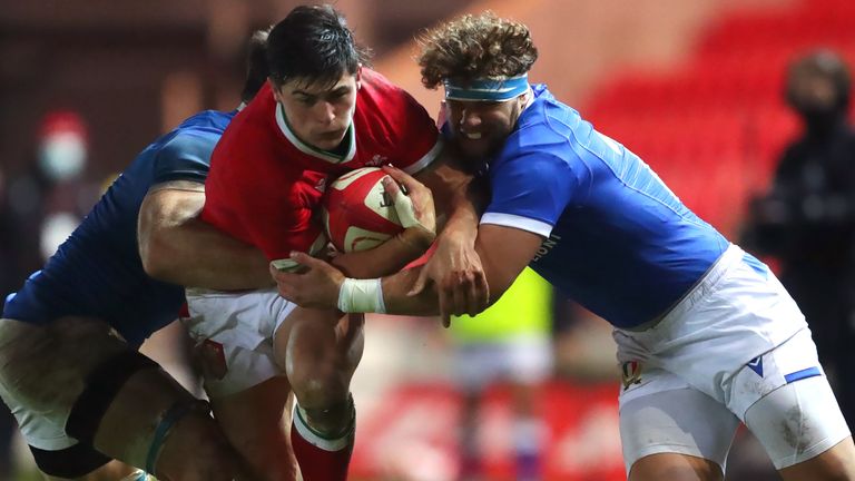 Wales' Louis Rees-Zammit (centre) tackled by Italy's Federico Mori during the Autumn Nations Cup match at Parc y Scarlets, Llanelli.