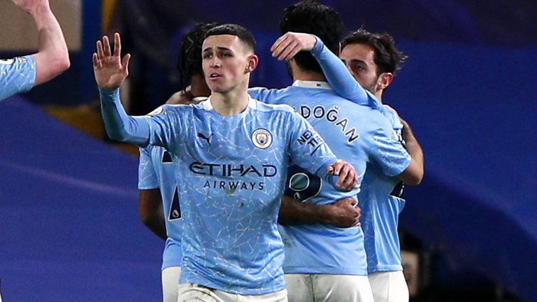 Manchester City players celebrate Ilkay Gundogan's opening goal at Stamford Bridge